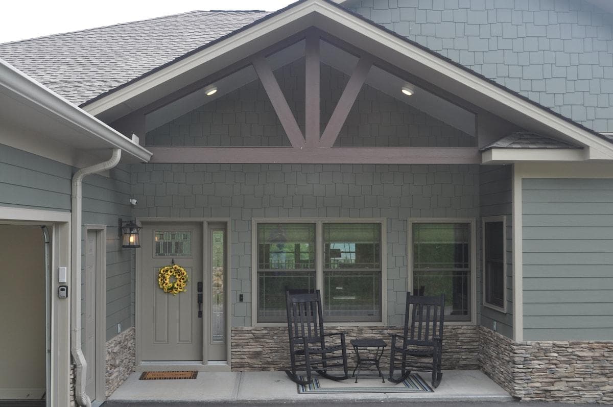 The parking pad is flat and wider than a two car garage.  The parking pad black top is skimmed up to the front porch concrete only leaving a small edge for water retention/drainage.  Wheelchair ramp is located in garage door entryway but can be moved